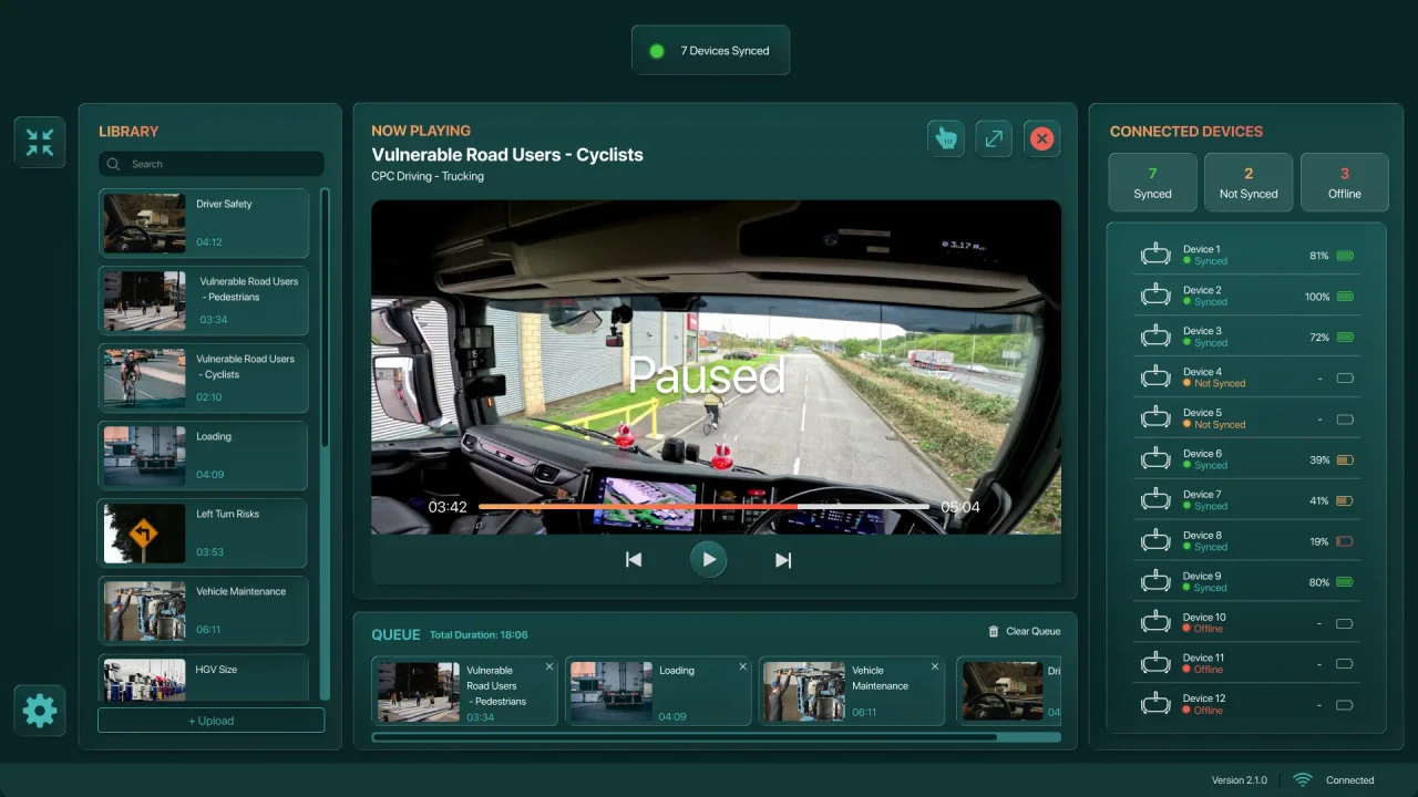 Briefcase Control interface with a searchable video library, playback and queue, plus battery and connection states for twelve headsets.